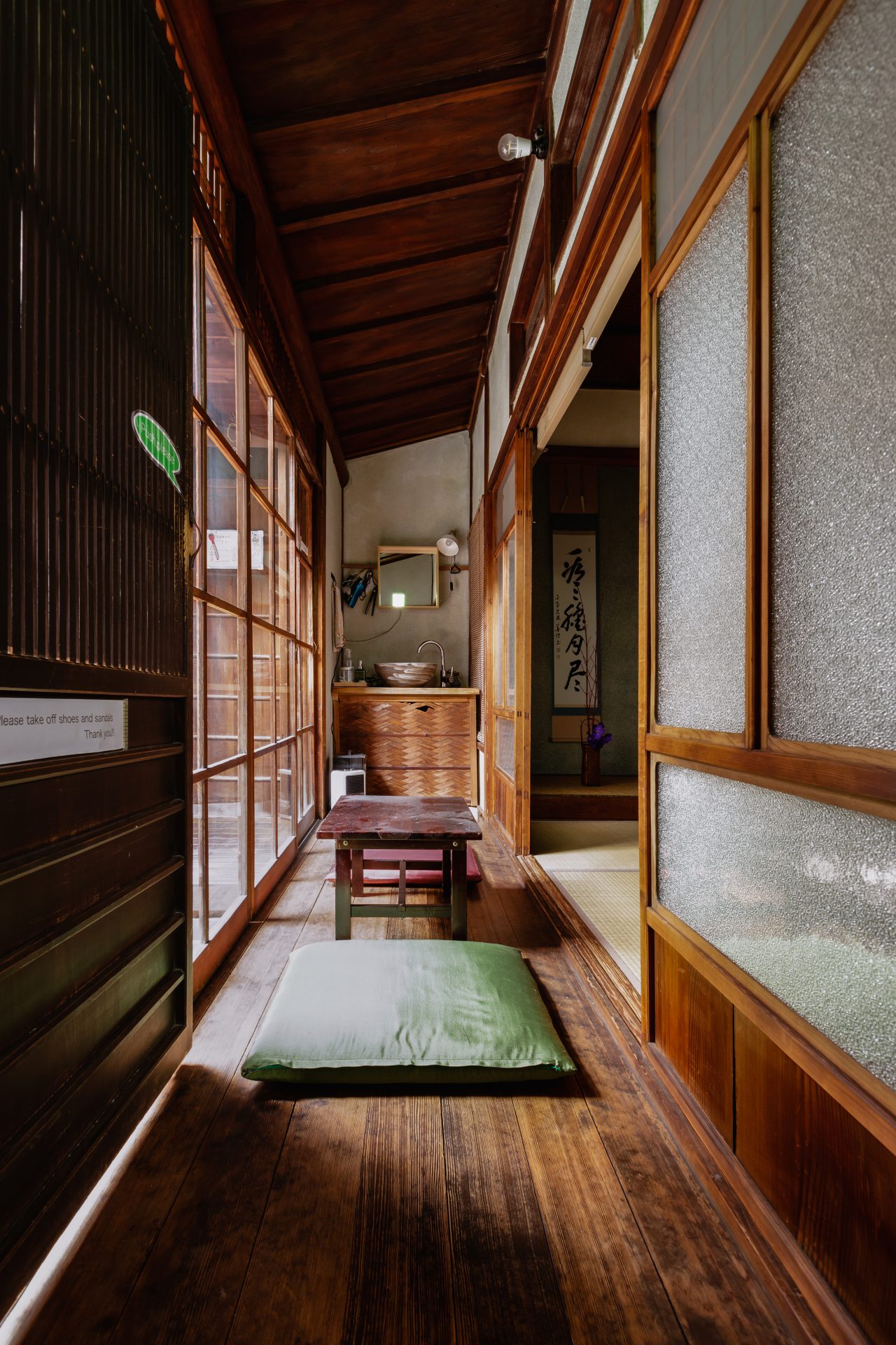 画像: 日本の伝統的な家屋の廊下を撮影した写真。畳の部屋と美しい木製の床が特徴的で、静謐な和の雰囲気を醸し出